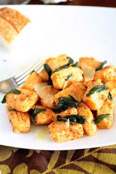 a white plate topped with tofu and spinach