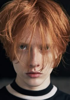 a close up of a person with red hair