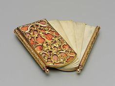 an ornately decorated book with gold trimmings