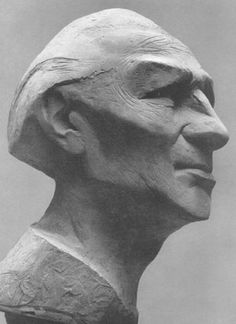 an old man's head is shown in this black and white photo, as if it were carved out of wood