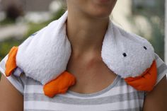 a woman wearing an orange and white towel around her neck