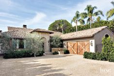 a large house with two garages in front of it