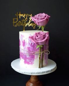 a birthday cake with pink roses on top