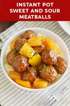 a white bowl filled with meatballs and pineapples on top of a table