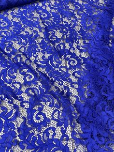 blue lace fabric with white flowers on it