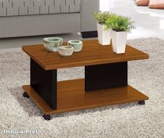 a coffee table with two planters on it