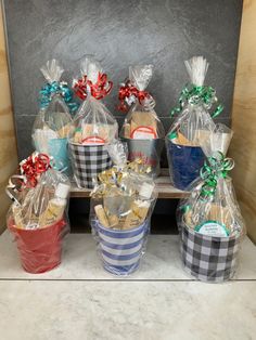 several baskets filled with cookies sitting on top of a counter next to each other and wrapped in cellophane