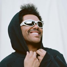 a man wearing sunglasses and a hoodie