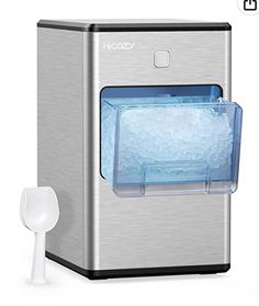 the ice maker is next to a white spoon and an object that looks like it has been frozen