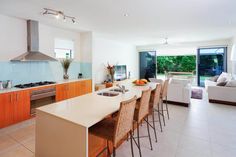 a kitchen with an island and lots of counter space in front of a sliding glass door