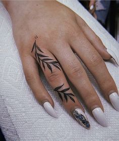 a woman's hand with some tattoos on it