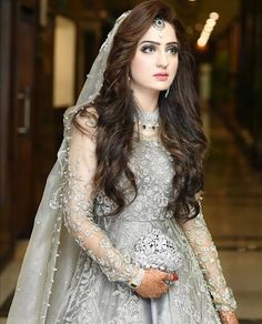 a woman in a wedding dress with long hair