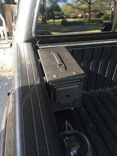 the back end of a pickup truck with an electronic device in it's bed