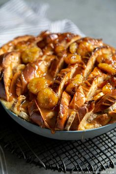 a dish with bananas and caramel drizzled over it on a cooling rack