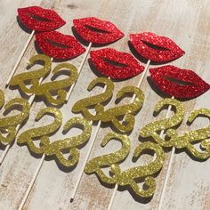 some red and gold glitter lips are on top of each other with the letter s