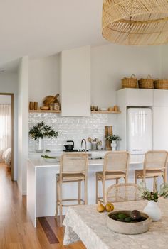 the kitchen is clean and ready to be used for dinner or lunchtime, with wicker hanging from the ceiling