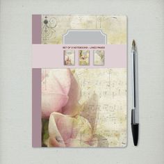 a notepad with an image of a rose on it and a pen next to it