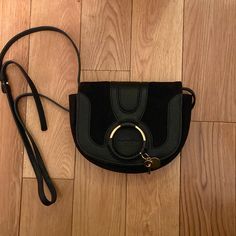 See By Chloe Mini Hana Crossbody Bag In Black. Excellent Condition. Dust Bag Included Evening Saddle Bag With Branded Hardware In Black, Evening Black Saddle Bag With Branded Hardware, Black Saddle Bag With Branded Hardware For Evening, Chic Black Saddle Bag With Branded Hardware, Luxury Black Saddle Bag With Silver-tone Hardware, Chloe Bags, Chloe Handbags, See By Chloe, Crossbody Bags