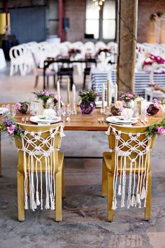 the table is set with white and purple flowers