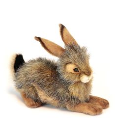 a stuffed rabbit sitting on top of a white surface