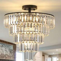 a chandelier hanging from the ceiling in a living room