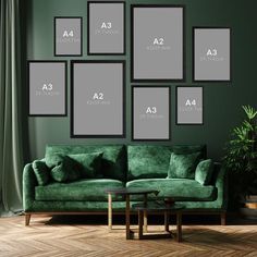 a living room with green couches and pictures on the wall above them, along with a coffee table