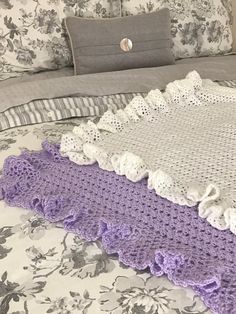 there is a crocheted blanket on the bed