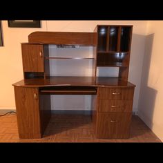 a wooden desk with two drawers and cupboards