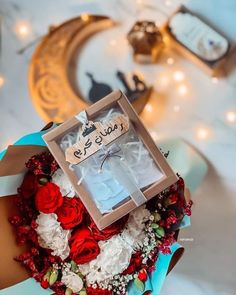 a box that has some kind of decoration on it with flowers and candles in the background