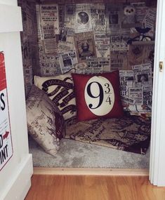 there is a small room with newspaper on the wall and a pillow in the corner