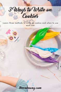 a child is painting on some cookies with the words, 3 ways to write on cookies