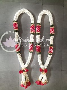 two white and red beaded necklaces with bells