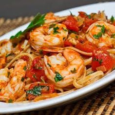 pasta with shrimp and tomatoes on a white plate