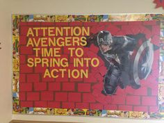 an advertisement for the avengers movie is displayed on a wall in a room with red brick walls