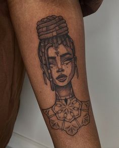 a woman's leg with a tattoo on it that has an image of a woman wearing a headdress