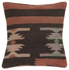 a brown and black pillow with multicolored designs on it's back side