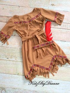 a brown dress with red feathers on it