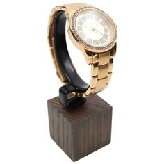 a watch sitting on top of a wooden stand