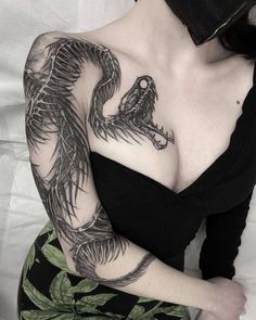 a woman with a dragon tattoo on her chest