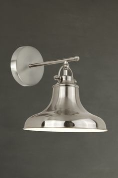 an industrial style light fixture on a gray wall