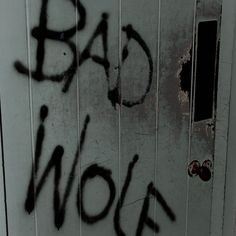 a door with the words bad wolf spray painted on it