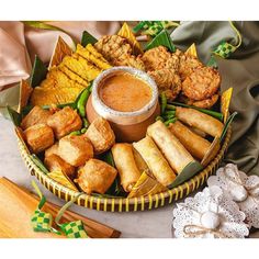 a basket filled with lots of different types of food next to marshmallows