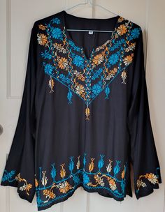 "*An authentic, vintage Bohemian Egyptian tunic top with beautiful Arabic embroidered decorative detail. *Scoop neckline with small split. *Side splits *  Polyester material/mixed fibres *A rare find, not available on the High Street, with the essence of original vintage 70s style.  *Not to be missed!! Measurements:    Chest:  38\"    Length:  27\"     Hem:  44\"" Bohemian V-neck Top With Resham Embroidery, Traditional Long Sleeve Tunic With Embroidered Hem, Bohemian Long Sleeve Kurta With Embroidered Hem, Multicolor Embroidered Long Sleeve Tunic, Bohemian Long Sleeve Kurta With Embroidered Neckline, Traditional V-neck Embroidered Peasant Top, 70s Vintage Fashion, Black Tunic Tops, Embroidered Tunic Dress