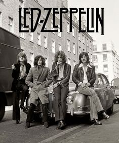 the led - zeppelun band is posing in front of an old car