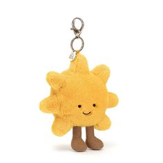 a yellow stuffed animal keychain with a smiling star on it's face