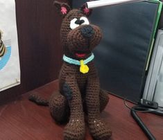 a crocheted dog sitting on top of a desk