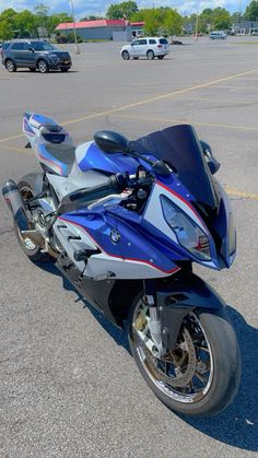 a blue motorcycle parked in a parking lot