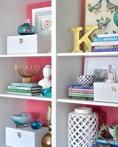 two shelves with books, vases and other decorative items on top of each shelf