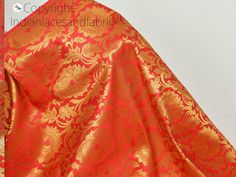 "Indian Brocade Fabric by the Yard Banarasi Coral Red Gold Bridal Lehenga Wedding Dress Blended Silk Costumes Home Decor Upholstery Curtains This is a beautiful heavy Banarasi art silk brocade floral design fabric in Royal Blue and Gold. ➤Product: Brocade Fabric ➤Fabric Type: Blended Silk (Viscose and Silk) Fine quality Zari Brocade Weaving from Banaras ➤Color: Coral Red and Gold ➤Width: 44 inches. ➤Condition: New ➤Code: bg2153 ➤Listing for 1 Yard of fabric. ➤Care: Dry Clean Only This is known a Red Brocade Lehenga With Dupatta, Red Brocade Choli With Dupatta, Red Bollywood Brocade Lehenga, Fitted Red Brocade Choli, Red Brocade Dupatta With Traditional Drape, Red Brocade Lehenga With Zari Work, Red Brocade Choli For Traditional Ceremonies, Red Anarkali Lehenga In Brocade, Anarkali Red Brocade Lehenga