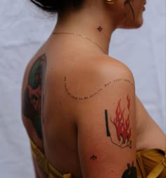 a woman with tattoos on her arm and shoulder